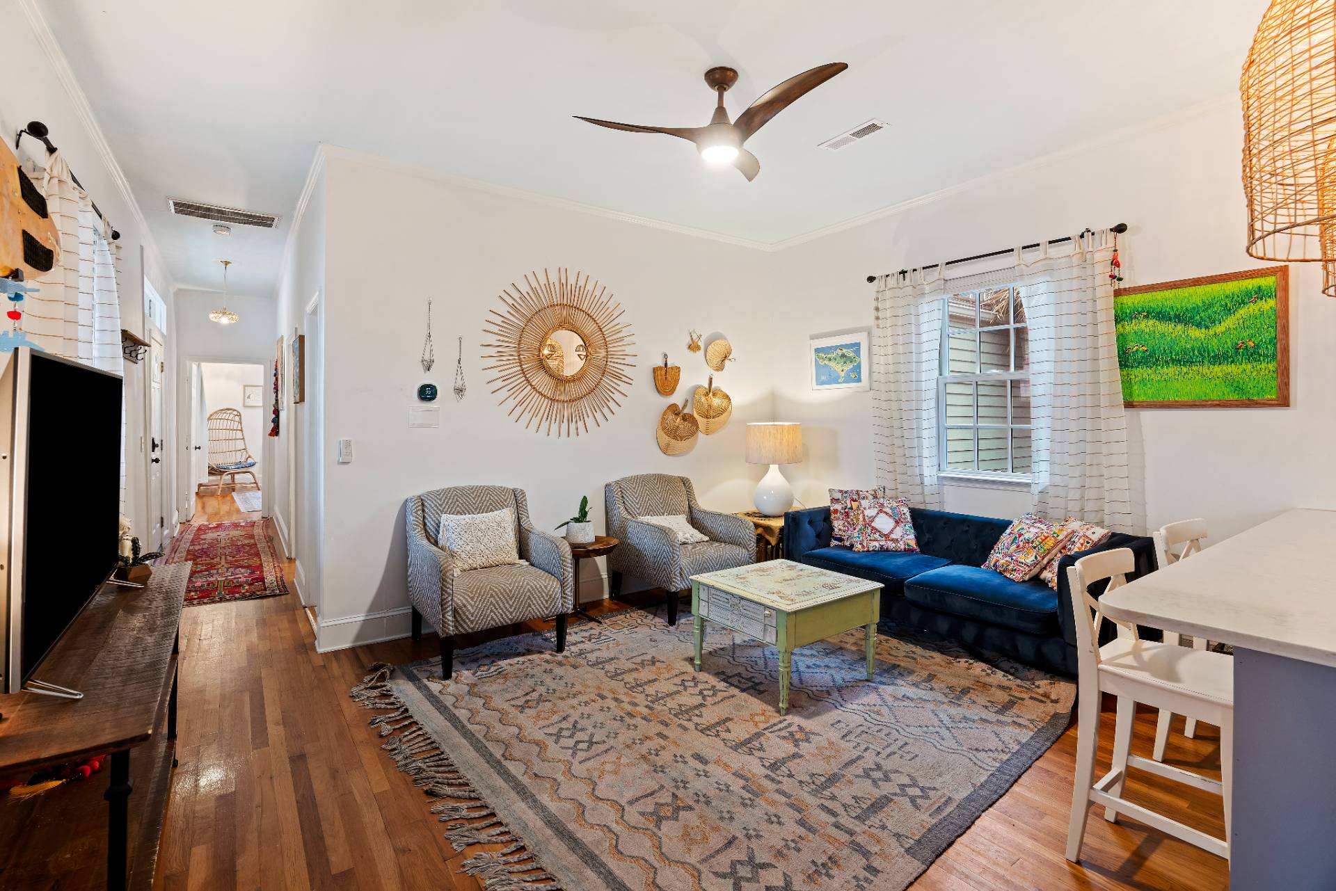 Suite B living room with sunburst mirror